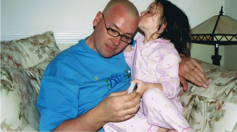 Ciara Fleming, who was diagnosed with a rare tissue cancer at age 23 months, kisses her father Donal’s shaved head. Ciara completed her treatment when she was a toddler and is 18 and cancer-free today. Donal Fleming has raised more than $1.3 million on behalf of the nonprofit St. Baldrick Foundation. Contributed