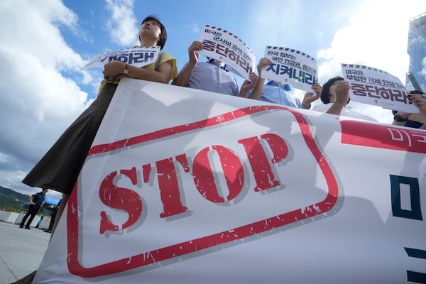 Members of civic groups protest against U.S. President Donald Trump's tariffs policy on South Korea, near the U.S. embassy in Seoul, South Korea, Tuesday, July 22, 2025. The banners reads " The U.S. should stop raising unfair tariffs and pressuring for increased military spending."(AP Photo/Ahn Young-joon)