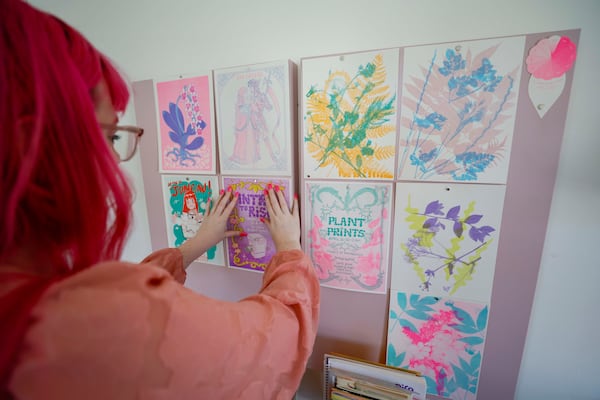 Richardson displays prints from the last Risograph workshop at Posy Press. Since December, Posy Press has been hosting Riso workshops for beginners and advanced students to explore various techniques that produce vibrant prints. (Miguel Martinez/AJC)