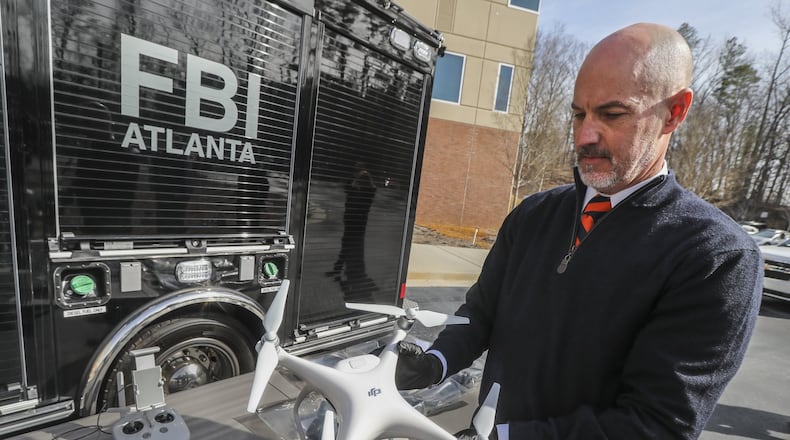 FBI Special Agent John Cronier with one of the six captured drones on Friday, Feb. 1, 2019, at the FBI Field Officer in Atlanta.