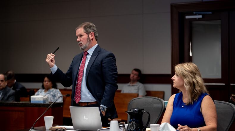 Plaintiff Alicia Adams (right) listens as her attorney Chuck Boring gives oral arguments to Judge Kellie Hill in Cobb Superior Court Thursday regarding her candidate disqualification lawsuit. The lawsuit could determine the legality of Cobb County's district map. Thursday, June 20, 2024 (Ben Hendren for the Atlanta Journal-Constitution)