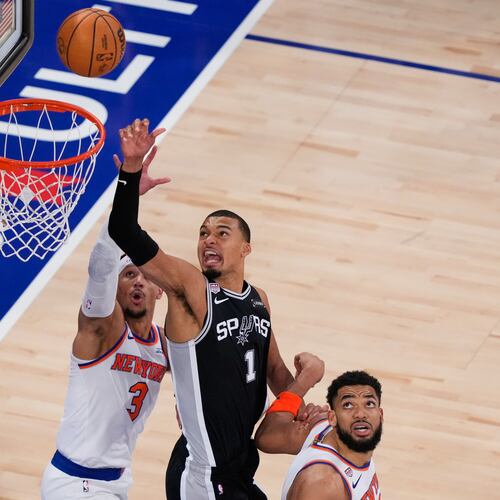 San Antonio Spurs forward Victor Wembanyama (1) shoots as New York Knicks guard Josh Hart (3) and center Karl-Anthony Towns (32) defend during the second half of Game 3 of the NBA Finals basketball series, Monday, June 8, 2026, in New York. (AP Photo/Yuki Iwamura)