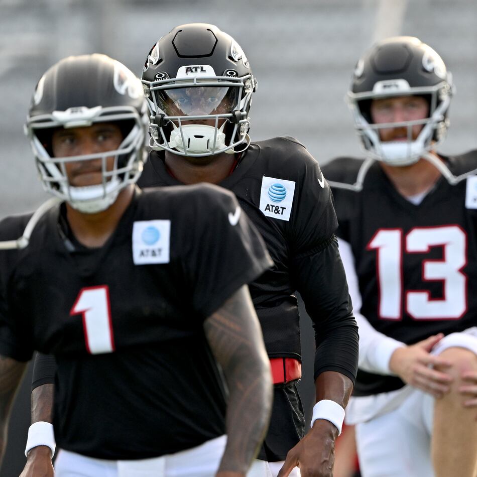 Atlanta Falcons quarterbacks, from left, Tua Tagovailoa (left), Michael Penix Jr. (second from left), Cooper Rush (second from right) and Jack Strand (right) warm up during the Atlanta Falcons' Saturday Night Lights practice at Lanier High School on Saturday, Aug. 8, 2026, in Sugar Hill. (Hyosub Shin/AJC)