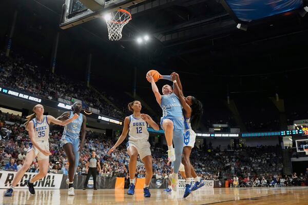 North Carolina guard Alyssa Ustby (1) goes to the basket against Duke guard Oluchi Okananwa during the first half in the Sweet 16 of the NCAA college basketball tournament, Friday, March 28, 2025, in Birmingham, Ala. (AP Photo/Gerald Herbert)