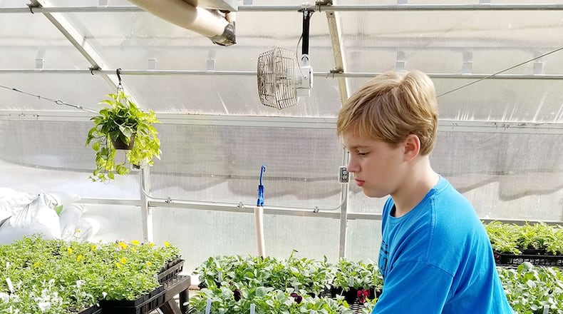 West Jackson Middle schooler Michael Howard works on a horticulture project for his agriculture education class. The school recently won national recognition for its program.