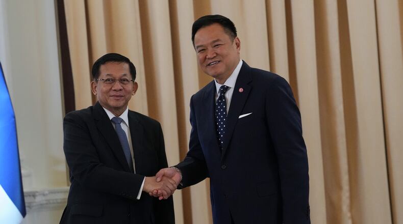 Myanmar President Min Aung Hlaing, left, shakes hands with Thailand's Prime Minister Anutin Charnvirakul at the government house in Bangkok, Thailand, Thursday, Aug. 6, 2026. (AP Photo/Sakchai Lalit)
