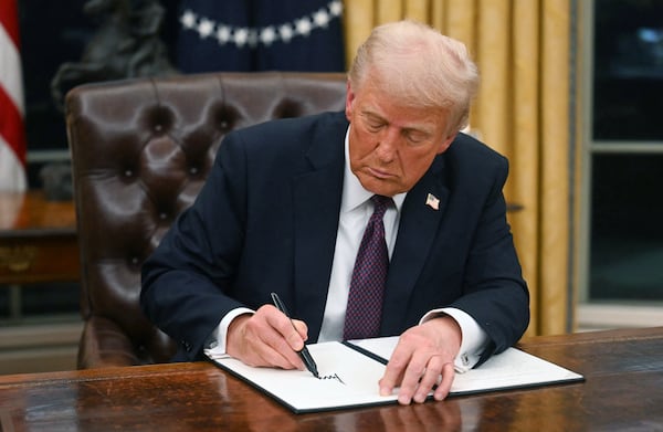 US President Donald Trump signs an executive order in the Oval Office of the White House in Washington, DC, on Jan. 20, 2025. (Jim Watson/Pool/AFP/Getty Images/TNS)