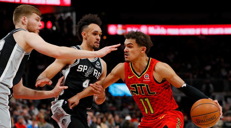 Trae Young of the Hawks drives against the Spurs.  (Photo by Kevin C.  Cox/Getty Images)