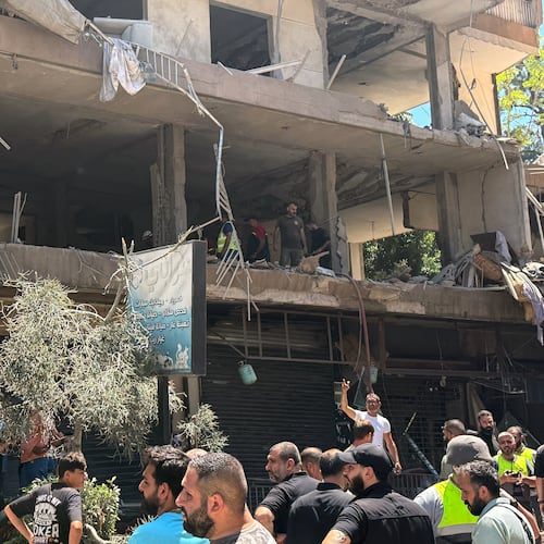 People gather at the site of an Israeli airstrike that struck an apartment in Dahiyeh, Beirut's southern suburbs, Lebanon, Sunday, June 14, 2026. (AP Photo/Bilal Hussein)