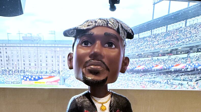A Tupac Shakur bobblehead is displayed for the Baltimore Orioles' giveaway at a baseball game against the Athletics on Friday, May 8, 2026, in Baltimore. (AP Photo/Noah Trister)