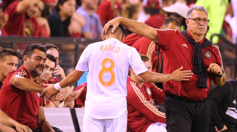 Atlanta United head coach Gerardo Martino gives Ezequiel Barco, who had a goal in the game, a pat on the head as he comes out of the game against Charleston Battery in a U.S. Open Cup match on Wednesday, June 6, 2018, in Kennesaw.