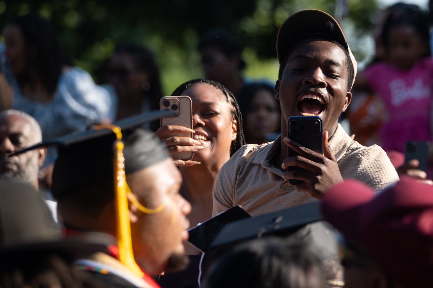 A person reacts as students walk to the Morehouse College graduation Sunday, May 17, 2026. (Ben Gray for the AJC)
