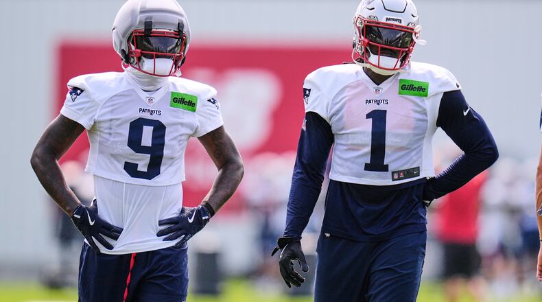 New England Patriots wide receivers A.J. Brown (1) and Kayshon Boutte (9) wait their turn on a drill during the team's NFL football training camp, Monday, Aug. 10, 2026, in Foxborough, Mass. (AP Photo/Charles Krupa)