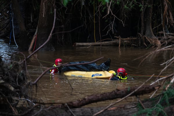 Firefighters from Ciudad Acuña, Mexico, perform a water recovery of a body in a portion of the flooded Guadalupe River after a flash flood swept through the area Monday, July 7, 2025, in Ingram, Texas. (AP Photo/Eli Hartman)