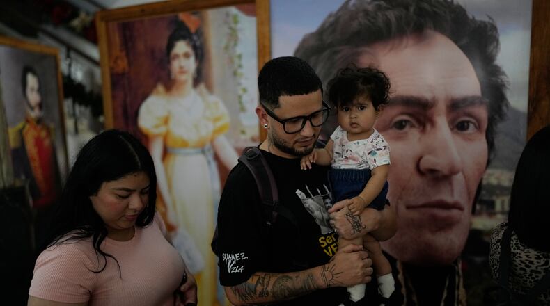 Arturo Suarez, a Venezuelan migrant sent by the U.S. to El Salvador and later deported to Venezuela, walks with his family after reading a statement at a government building in Caracas, Venezuela, Friday, Dec. 26, 2025. (AP Photo/Matias Delacroix)