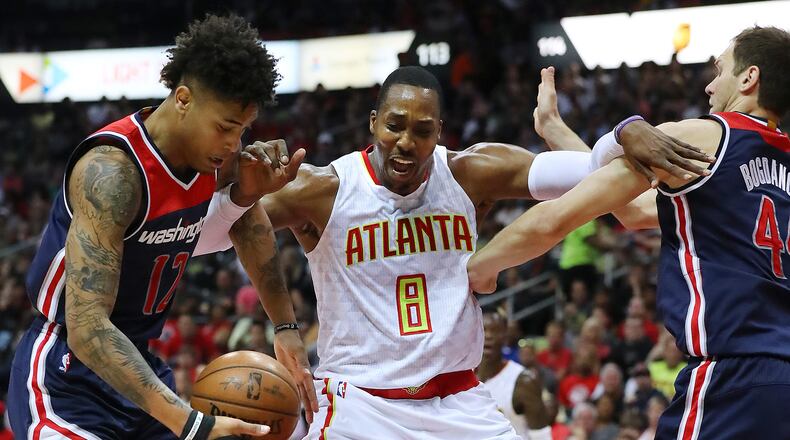 Atlanta Hawks’ Dwight Howard battles Washington Wizards Kelly Oubre Jr. and Bojan Bogdanovic under the basket in Game 3 of a first-round NBA basketball playoff series on Saturday, April 22, 2017, in Atlanta. Curtis Compton/ccompton@ajc.com