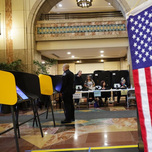 Workers wait for voters to arrive at a polling station on Tuesday, Nov. 4, 2025, in Los Angeles. (AP Photo/Ethan Swope)