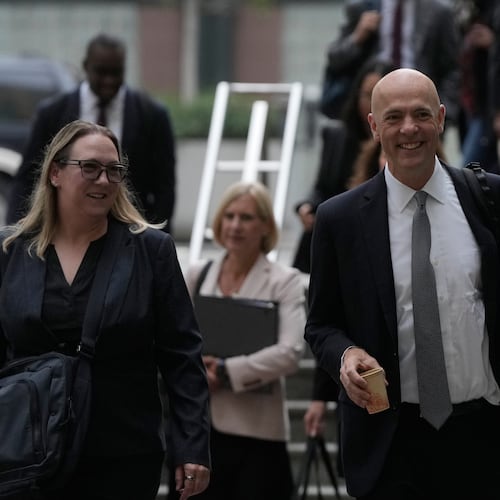 Attorney Paul W. Schmidt, representing Meta, right, arrives at a Federal Courthouse Wednesday, Aug. 12, 2026, in Oakland, Calif. (AP Photo/Jeff Chiu)