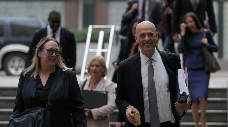 Attorney Paul W. Schmidt, representing Meta, right, arrives at a Federal Courthouse Wednesday, Aug. 12, 2026, in Oakland, Calif. (AP Photo/Jeff Chiu)
