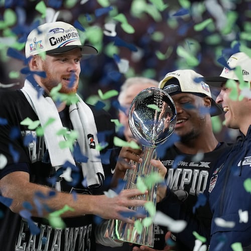 Seattle Seahawks head coach Mike Macdonald and quarterback Sam Darnold, left, hold the Lombardi Trophy after a win over the New England Patriots in the NFL Super Bowl 60 football game Sunday, Feb. 8, 2026, in Santa Clara, Calif. (AP Photo/Matt Slocum)