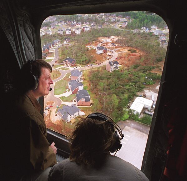 980410 - Marietta, Georgia - Vice President Al Gore is shown Friday, April 10, 1998 as he takes in an aerial view of damage incurred by recent storms and tornados in the metro-Atlanta area of Georgia. He and his wife, Tipper, shown with her back to camera in the bottom part of the photo, flew into Dobbins Reserve Air Force Base in Marietta to take a helicopter tour of the storm-ravaged areas. The area here is somewhere either in Dunwoody or Gwinnett County. (AJC Staff Photo/Andy Sharp)