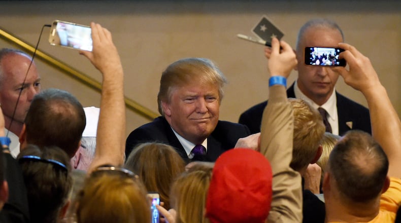 Republican presidential candidate Donald Trump greets supporters after speaking at a caucus night watch party at the Treasure Island Hotel & Casino in Las Vegas, Nev., on Tuesday. The New York businessman won his third state victory in a row in the "first in the West" caucuses. Ethan Miller/Getty Images