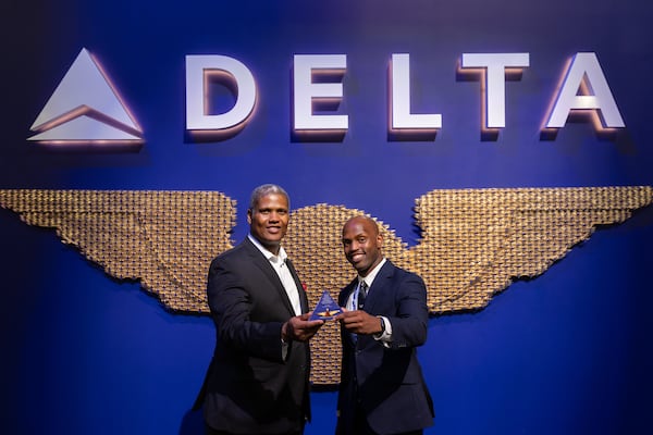 (L-R) Delta first officers Sean Allen and Jarred Lundy pose for a portrait with Allen's wing pin at a Delta pilot wing ceremony at the Delta Flight Museum in Hapeville on Wednesday, June 11, 2025. Allen passed on his wings to Lundy, his mentee, as part of Delta's "Legacy Wings" program. (Arvin Temkar / AJC)