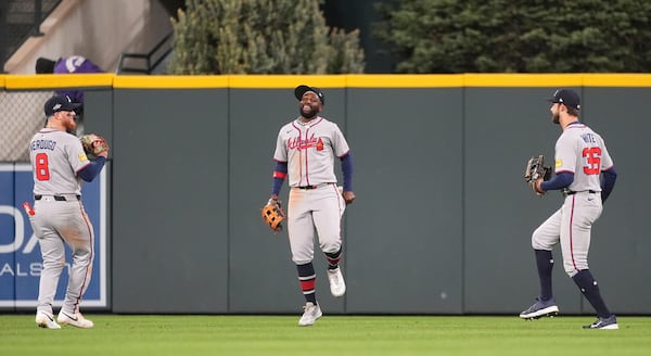 From left: Braves outfielders Alex Verdugo, Michael Harris II and Eli White celebrate Monday's win in Colorado.