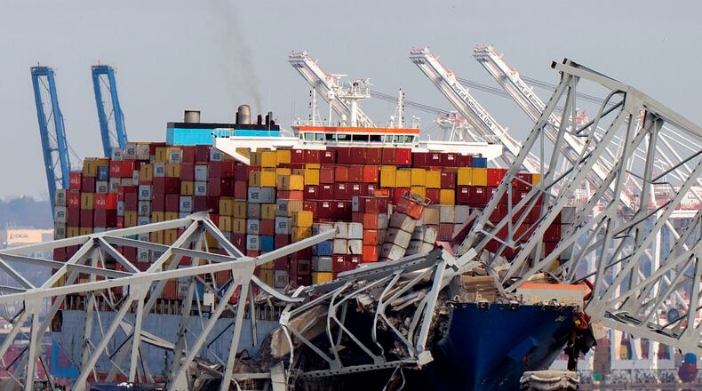 FILE - The cargo ship Dali is stuck under part of the Francis Scott Key Bridge after the ship hit the bridge, March 26, 2024, as seen from Pasadena, Md. (AP Photo/Mark Schiefelbein, File)