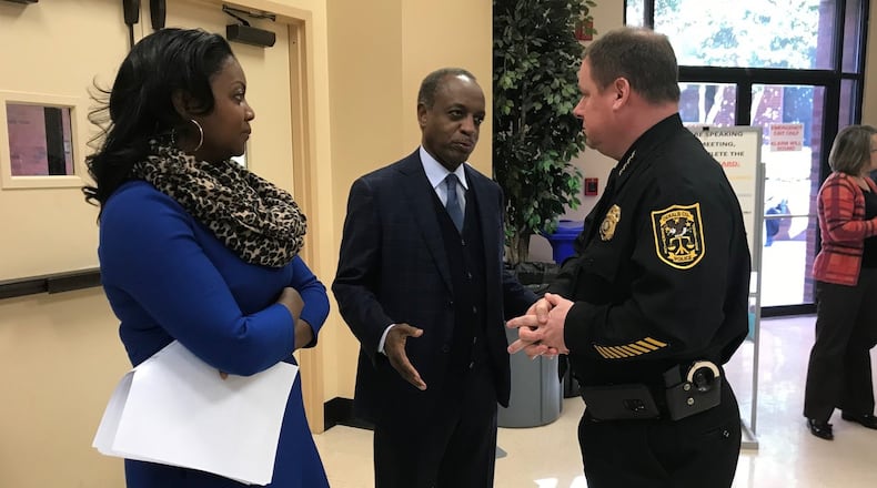 DeKalb County CEO Michael Thurmond (center) speaks to Police Chief James Conroy (right) before casting the deciding vote on new booting regulations during a meeting on Dec. 4, 2018. La’Keitha Carlos, Thurmond’s chief of staff, looks on. TIA MITCHELL/TIA.MITCHELL@AJC.COM