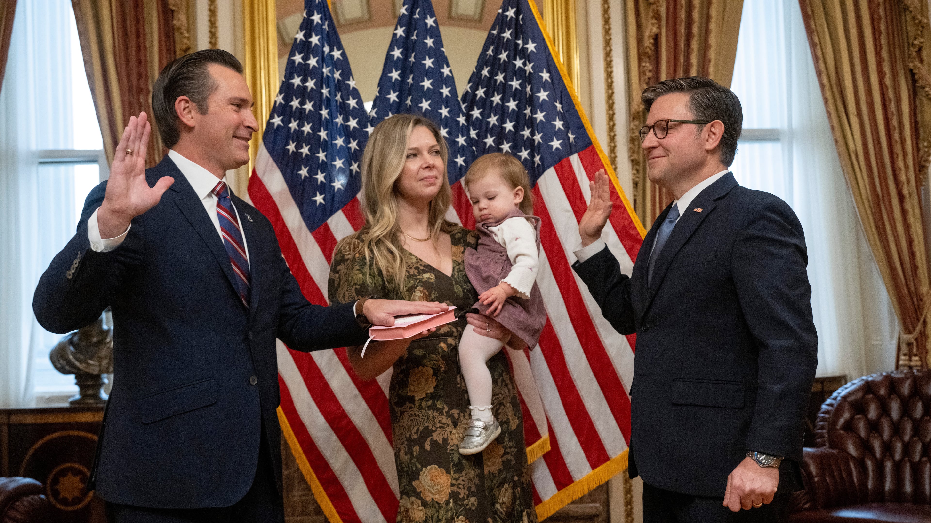 Rep. Matt Van Epps, R-Tenn, left, takes part in a ceremonial swearing-in with Speaker Mike Johnson, R-La., Thursday, Dec. 4, 2025, in Washington. Holding the Bible is Van Epps' wife, Meg Wrather, and their daughter, Amelia Van Epps. (AP Photo/Kevin Wolf)