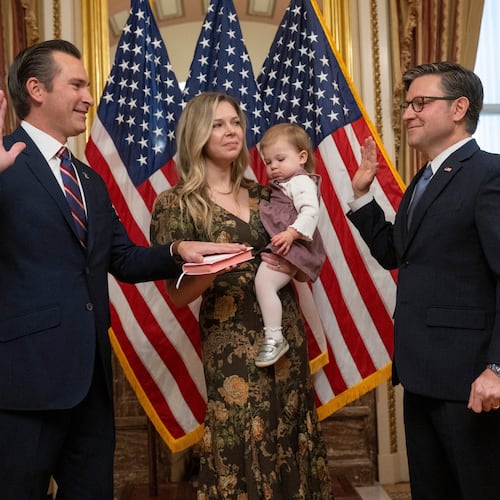 Rep. Matt Van Epps, R-Tenn, left, takes part in a ceremonial swearing-in with Speaker Mike Johnson, R-La., Thursday, Dec. 4, 2025, in Washington. Holding the Bible is Van Epps' wife, Meg Wrather, and their daughter, Amelia Van Epps. (AP Photo/Kevin Wolf)