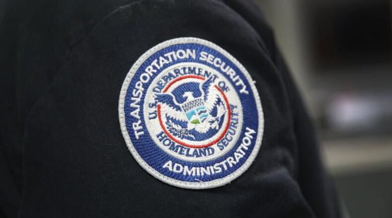 A TSA agent instructs travelers on traveling through security lines at Pittsburgh International Airport November 24, 2010.  (Photo by Jeff Swensen/Getty Images)