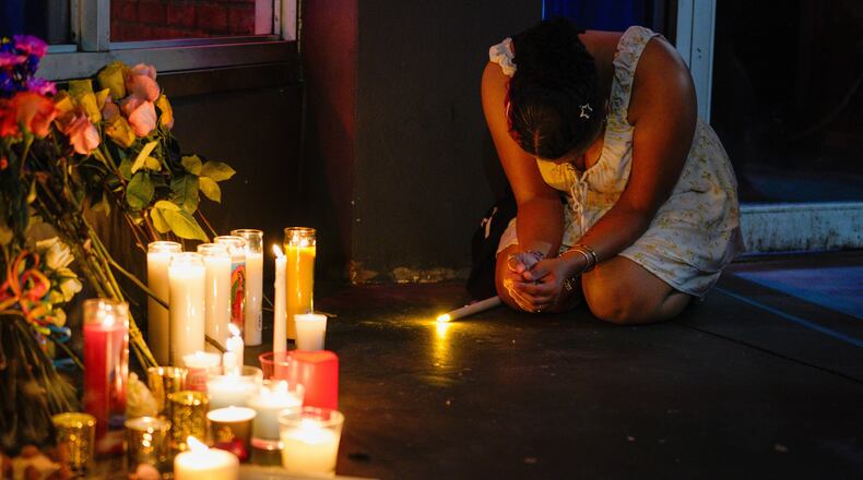 Heavyn Harris prays as she pays her respects during a vigil for the victims of an overnight crash of a vehicle involved in a high speed chase, which caused several deaths and multiple injuries at Bradley's on 7th, a popular LGBTQ+ nightclub, Saturday, Nov. 8, 2025, in Tampa, Fla. (Martha Asencio-Rhine/Tampa Bay Times via AP)