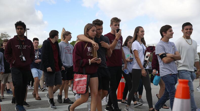 PARKLAND, FL - FEBRUARY 28: Students leave Marjory Stoneman Douglas High School after attending their classes for the first time since the shooting that killed 17 people on February 14 at the school on February 28, 2018 in Parkland, Florida. Police arrested 19-year-old former student Nikolas Cruz for the 17 murders. (Photo by Joe Raedle/Getty Images)