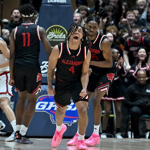 Alexander guard Gregory Dunson reacts after teammate Christian Moore dunked the ball against Woodward Academy at the end of fourth quarter during Class 5A Boys GHSA State Championship at the Macon Coliseum, Friday, March 13, 2026, in Macon. Alexander won 81-67 over Woodward Academy. (Hyosub Shin/AJC)