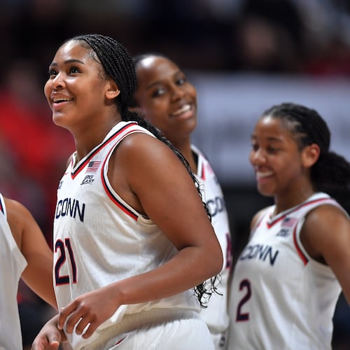 UConn forward Sarah Strong (21) celebrates with guards Azzi Fudd (35) and KK Arnold (2) as they lead Utah in the second half of an NCAA college basketball game, Sunday, Nov. 23, 2025, in Uncasville, Conn. (AP Photo/Steven Senne)