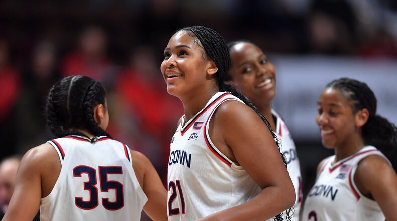 UConn forward Sarah Strong (21) celebrates with guards Azzi Fudd (35) and KK Arnold (2) as they lead Utah in the second half of an NCAA college basketball game, Sunday, Nov. 23, 2025, in Uncasville, Conn. (AP Photo/Steven Senne)