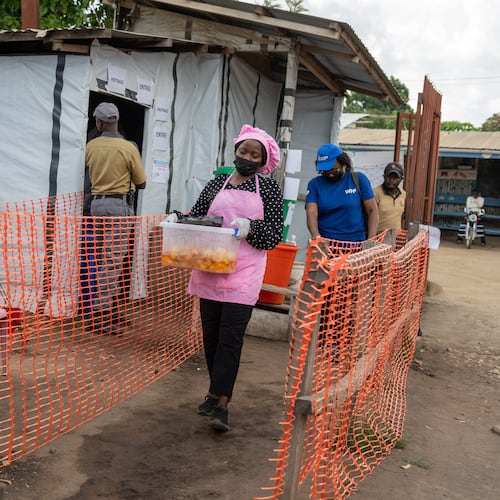 Kavugho Hortense, a cook, delivers meals to the medical staff and Ebola patients at the Evangelical Medical Center (CEM) in Bunia, Congo, Monday, June 1, 2026. (AP Photo/Moses Sawasawa)