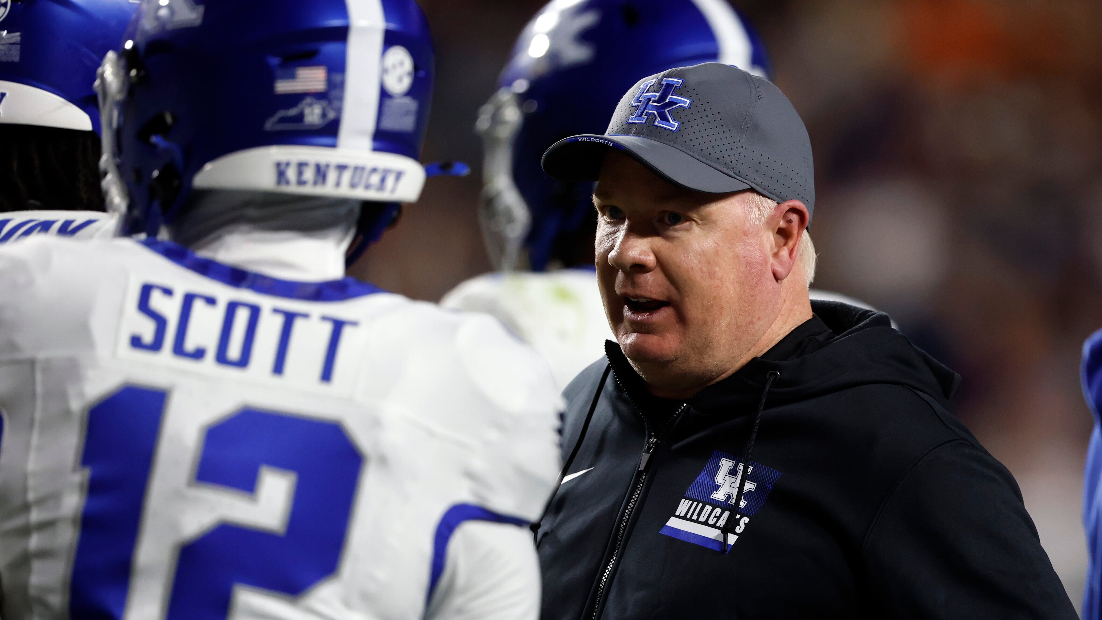 Kentucky head coach Mark Stoops talks with players during a timeout in the first half of an NCAA college football game against Auburn, Saturday, Nov. 1, 2025, in Auburn, Ala. (AP Photo/Butch Dill)