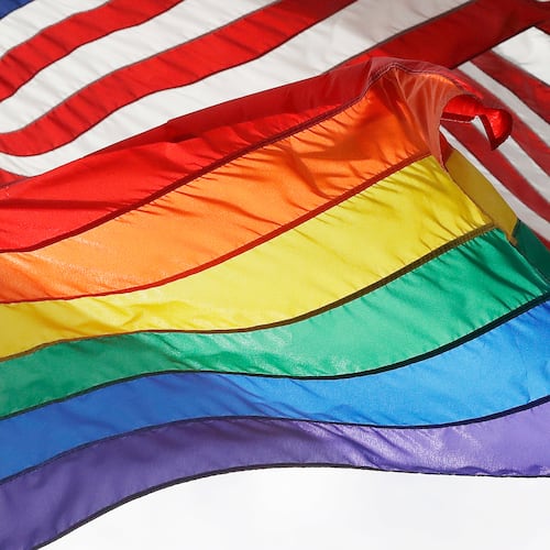 FILE - An LGBTQ+ pride flag flies beneath a U.S. flag at the Stonewall National Monument in New York, on Oct. 11, 2017. (AP Photo/Mark Lennihan, File)
