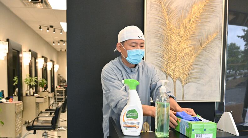 April 23, 2020 Duluth - Jay Choi, owner of Kara Hair, installs a plexiglass at front desk as a part of preparations before he opens his hair salon tomorrow on Thursday, April 23, 2020. "I try everything I can to protect our customers and our staff from Coronavirus. We will operate by appointment only and ask a customer to wear a mask," said Jay Choi. Gov. Brian Kemp announced a gradual reopening of the economy Monday. Businesses including salons, barbershops, tattoo parlors, gyms, bowling alleys and nail salons will be able to welcome customers Friday. (Hyosub Shin / Hyosub.Shin@ajc.com)