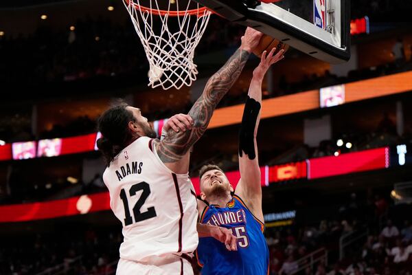 Houston Rockets center Steven Adams (12) blocks a shot by Oklahoma City Thunder center Isaiah Hartenstein (55) during the first half of an NBA basketball game in Houston, Friday, April 4, 2025. (AP Photo/Ashley Landis)