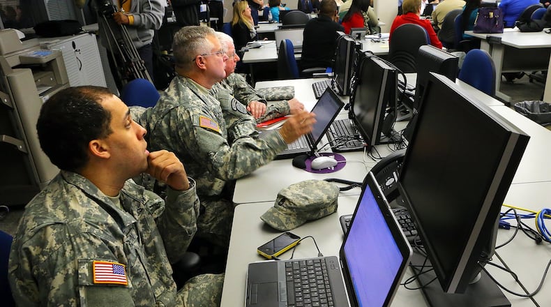 Sergeant First Class Gerald Brown (from left), Georgia National Guard, Staff Sergeant Buck Filby and Warrant Officer Alvin Moses, both with the State Defense Force, look on as state agencies prepare for the approaching winter weather, at the Georgia Emergency Management Agency State Operations Center on Monday, Feb. 10, 2014, in Atlanta. During the meeting Dale Brantley, with the GDOT, said “one of the big issues we are dealing with right now is salt supply.” Orders were apparently placed last week, but all of them have not been received yet. Brantley said they expected orders to be delivered throughout the night and into tomorrow. CURTIS COMPTON / CCOMPTON@AJC.COM