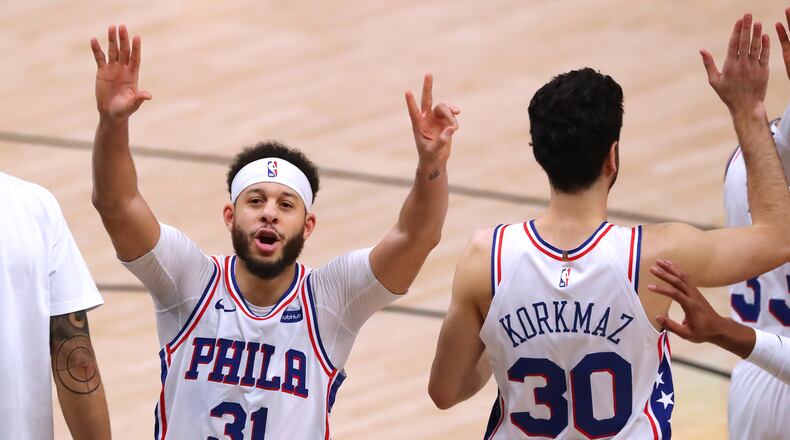 Philadelphia 76ers guard Seth Curry (left) lets the State Farm Arena crowd know there will be a Game 7 against the Hawks Sunday, at his place. “Curtis Compton / Curtis.Compton@ajc.com”