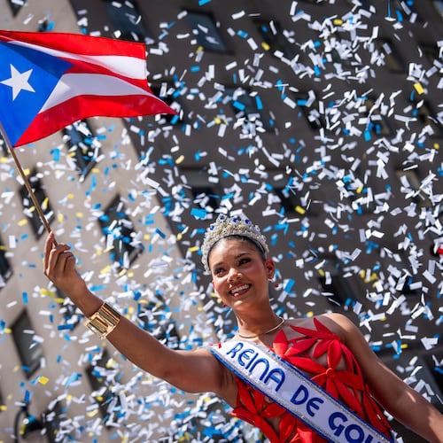 A person participates in the National Puerto Rican Day Parade, Sunday, June 14, 2026 in New York. (AP Photo/Adam Gray)