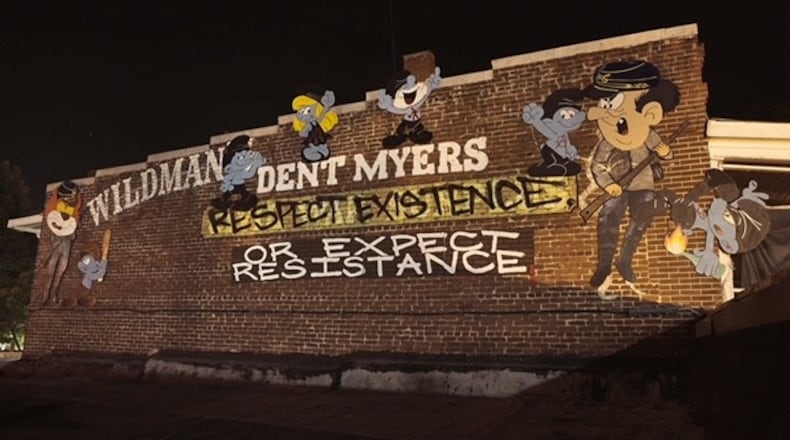 Indecline, a group of artists/activists painted "Antifa Smurfs" on a storefront in downtown Kennesaw where the controversial Wildman’s Civil War Surplus store is located. (Courtesy of Indecline)