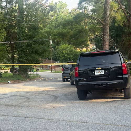 Multiple evidence markers are on a street near the DeKalb County shooting site, which remained blocked for several hours after early Thursday morning gunfire. (Eric Stirgus/AJC)