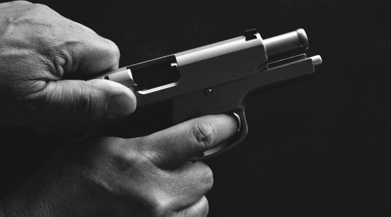 Photo illustration of a man holding a gun.