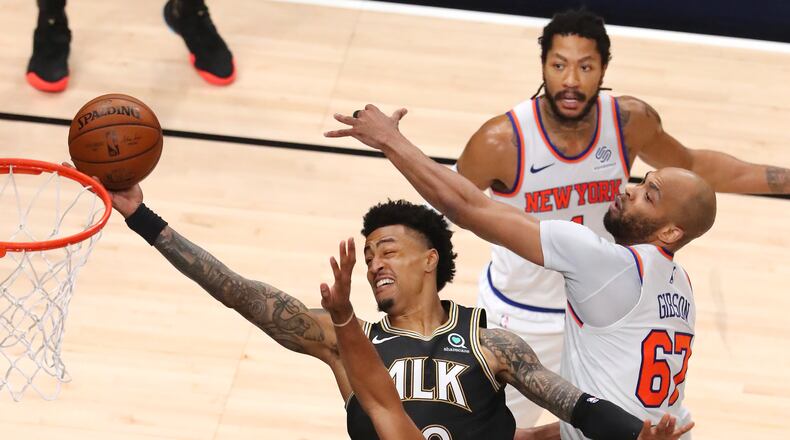 Hawks forward John Collins goes to the basket through a triple team by New York Knicks defenders Alec Burks (clockwise from bottom left), Derrick Rose and Taj Gibson during 113-96 Hawks win of Game 4 of first-round NBA playoff series Sunday, May 30, 2021, at State Farm Arena in Atlanta. (Curtis Compton / Curtis.Compton@ajc.com)